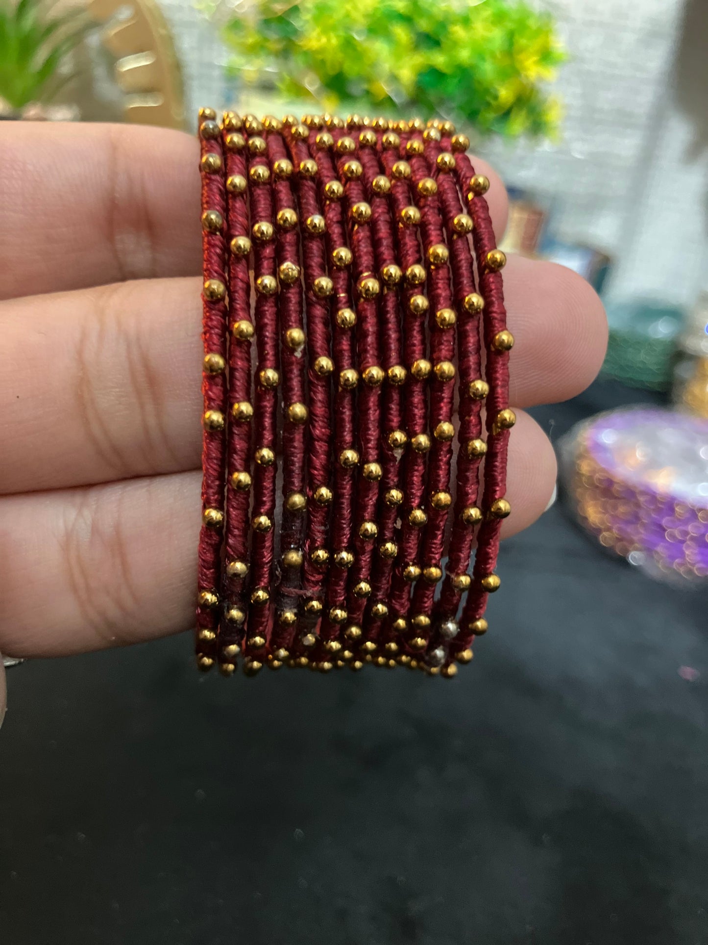 Silk Thread-wrapped metal bangles featuring gold-toned balls