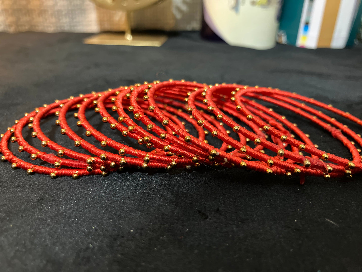 Silk Thread-wrapped metal bangles featuring gold-toned balls