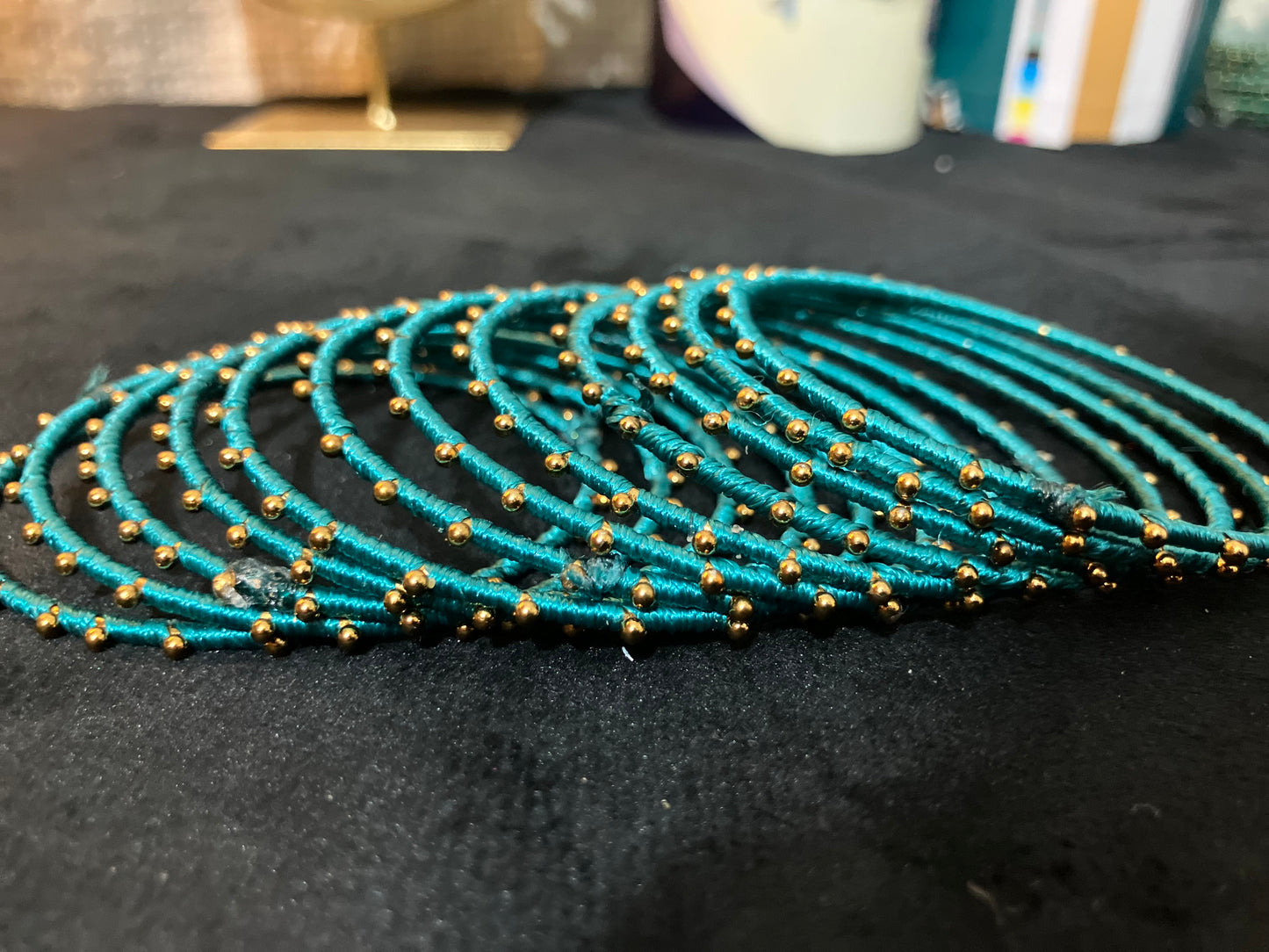 Silk Thread-wrapped metal bangles featuring gold-toned balls